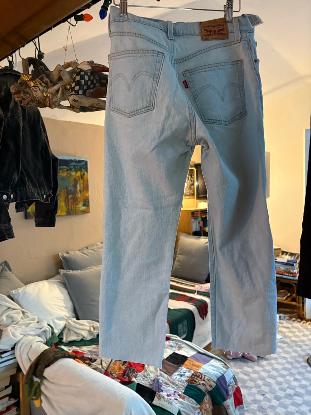 Straight-leg Levi’s 501 jeans with a raw-cut, lightly frayed hem.